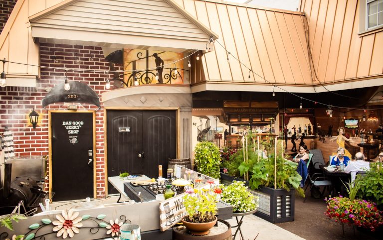 Patio seating with plants and people seated at tables